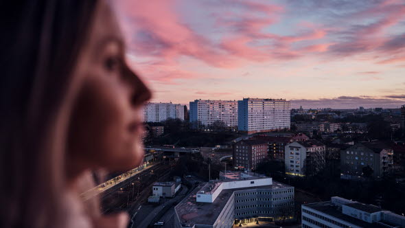 Woman looking out on a view of a city