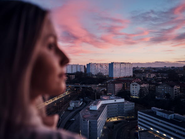 Woman looking out on a view of a city